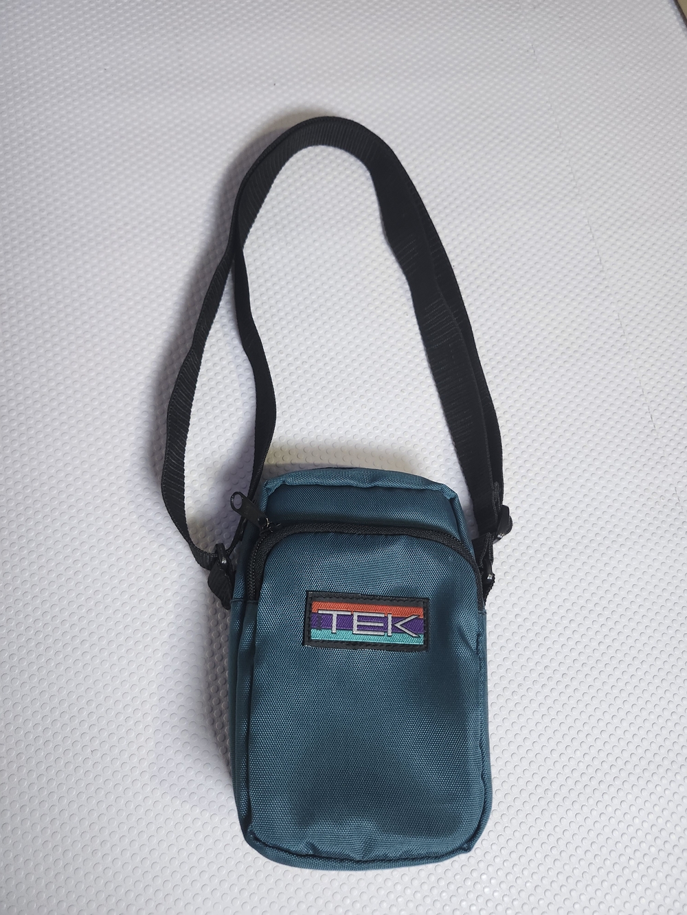 vintage teal blue TEK camera carrying bag featuring a rainbow-striped logo